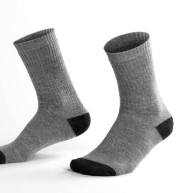 Gray socks with isolated leg shape on white background